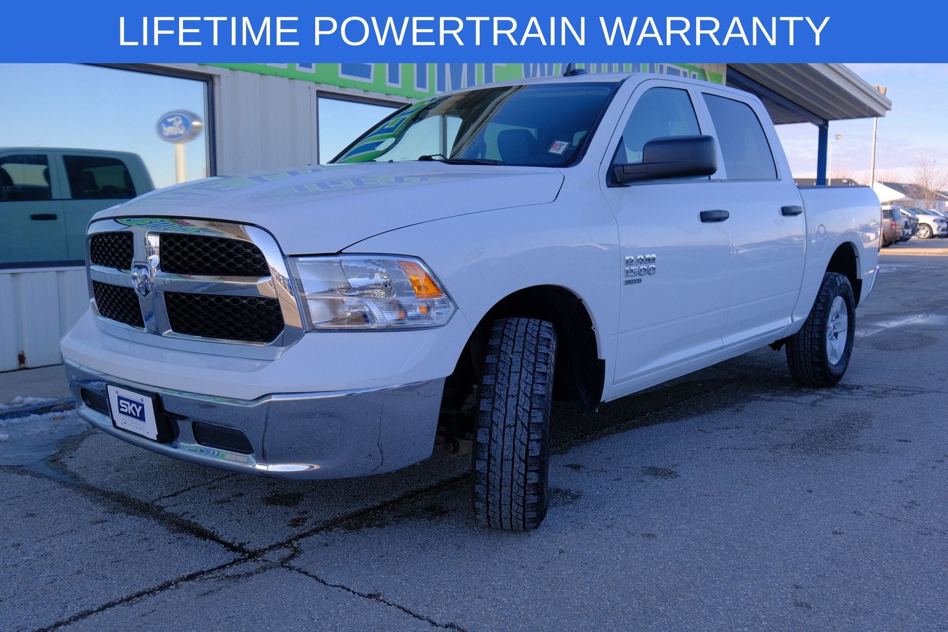 2023 RAM 1500 Classic SLT Crew Cab 4x4 5'7' Box in Bright White Clearcoat — front three-quarter view
